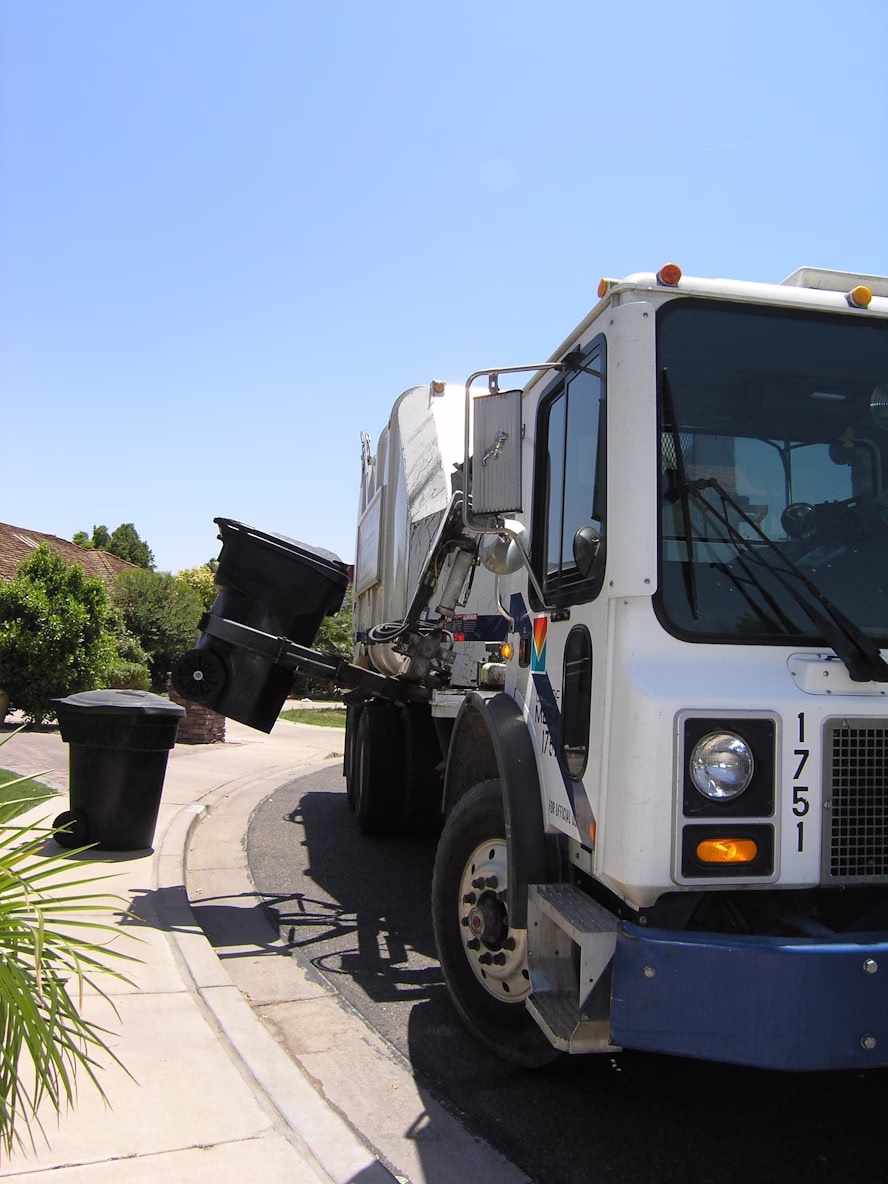 Residential garbage truck collecting a bin